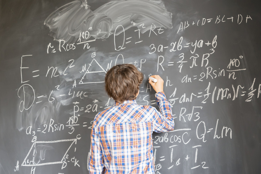 boy writing on blackboard