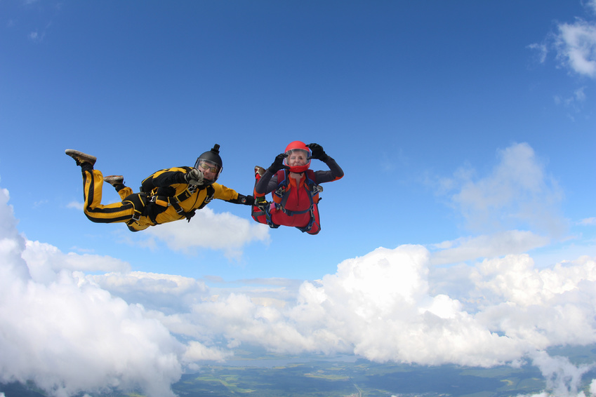 Two skydivers are in the sky.